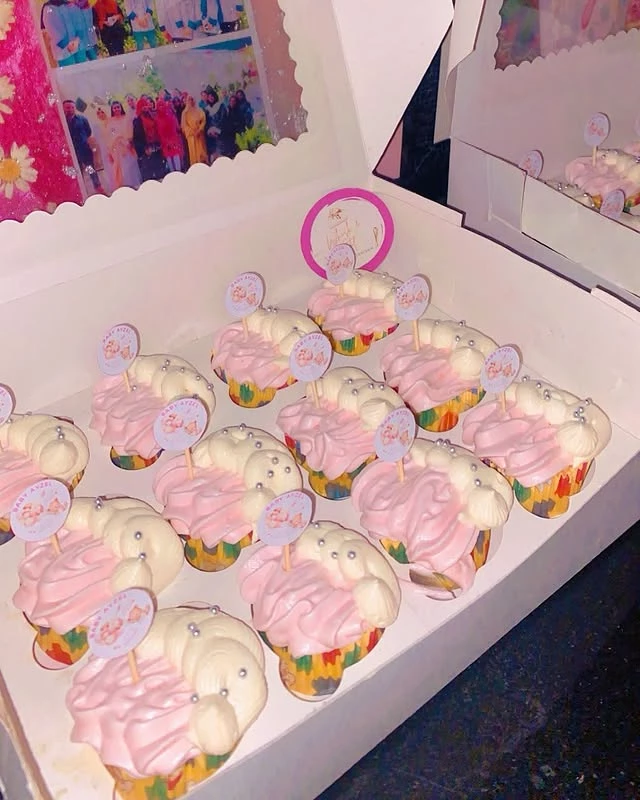 Gender reveal cupcakes with pink flower decorations for baby gender announcement party - Gender Reveal Party Treats Karachi By Whisk And Sift